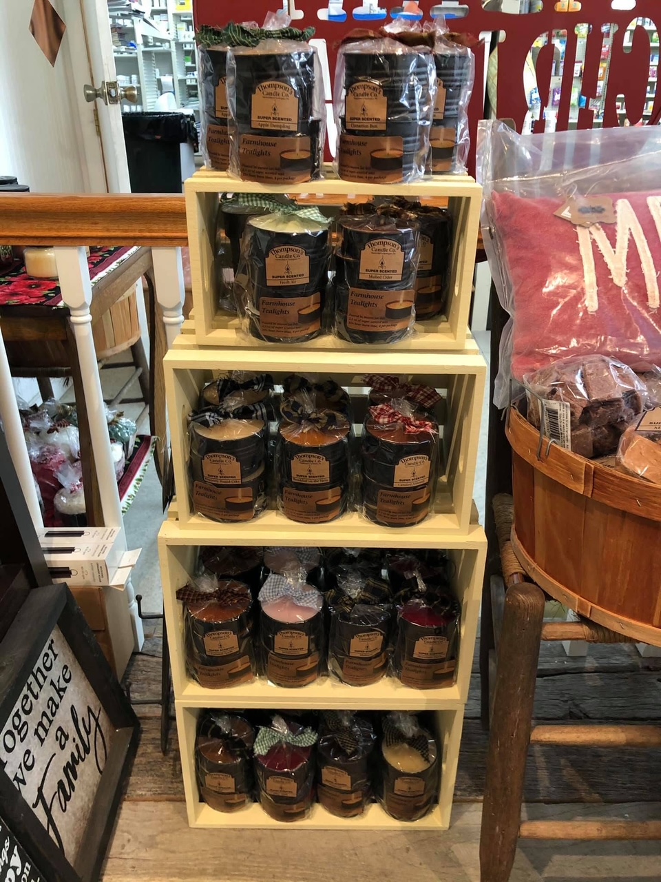 Thompson's Candle Co. farmhouse candles on wooden crate shelves